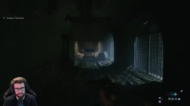 Aidan holding a firearm in the barred walkway during the Charlotte escape